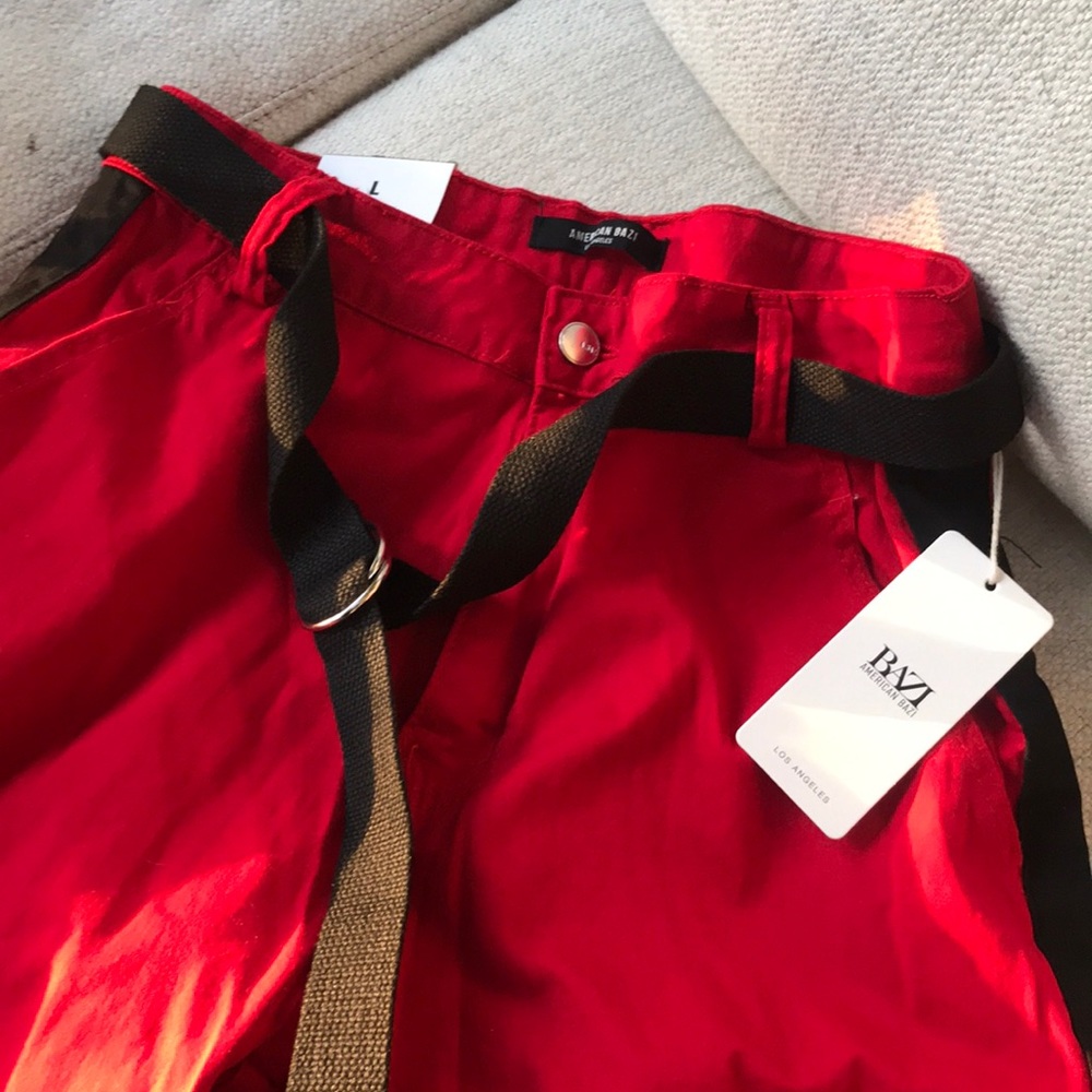 SOLD. NWT red pants with black line on the sides.